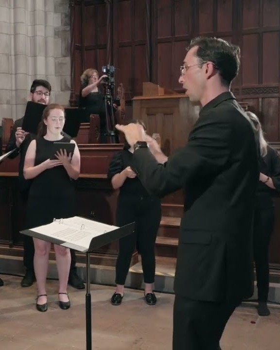 Conner McCain conducting a choir